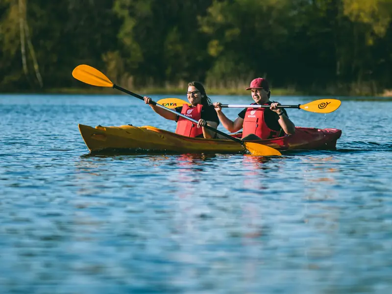 Two people paddling a kayak on a lake